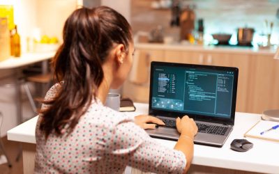 Programmer writing a malware for cyber attacks using performance laptop.